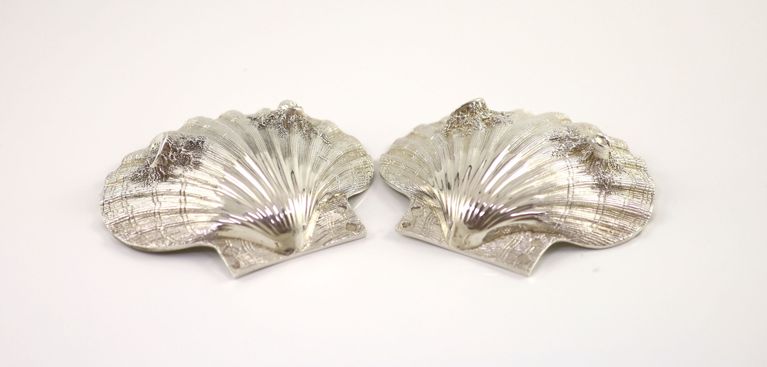 A pair of cast silver scallop shell butter dishes, C & J Vander, London 1975,